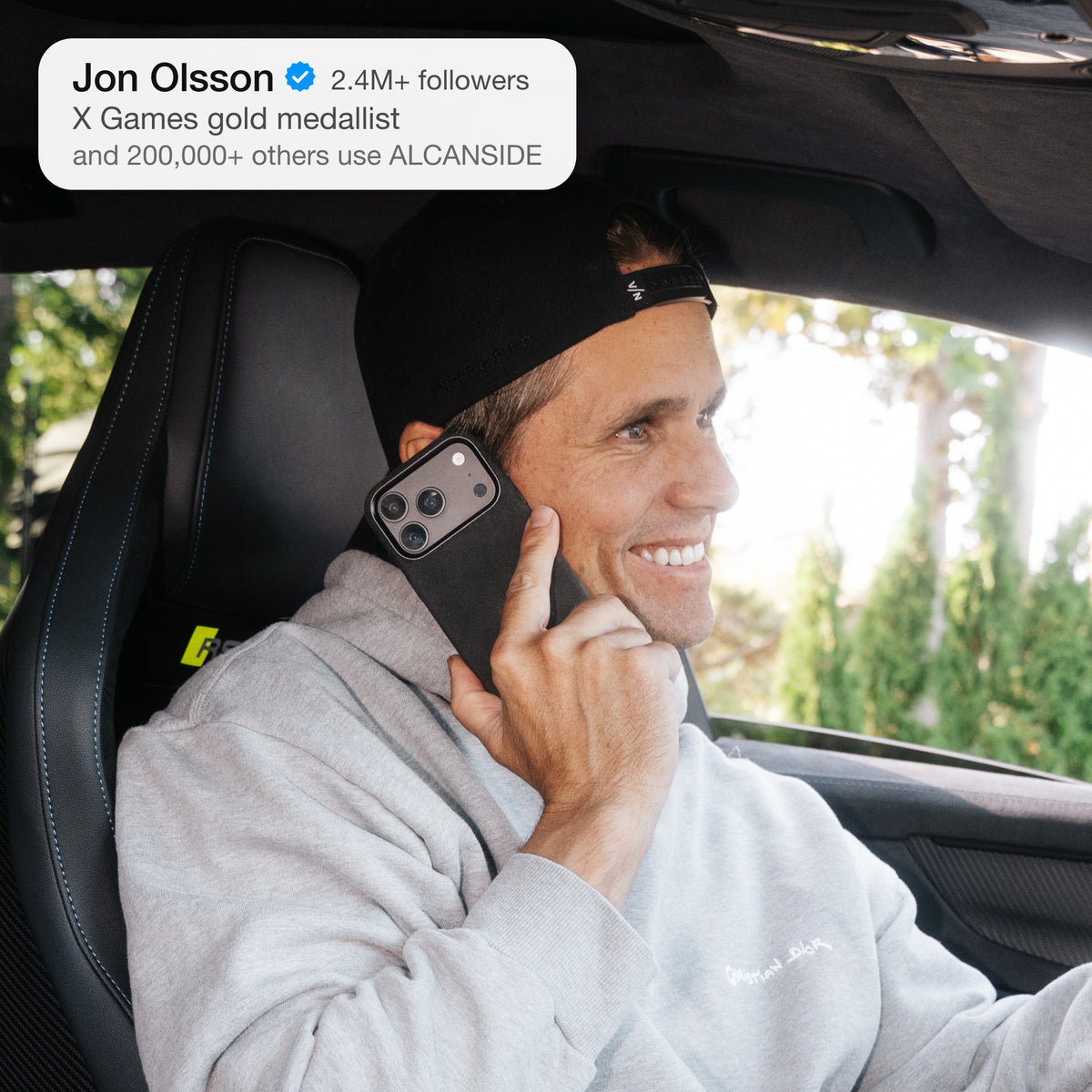 Jon Olsson on the phone in his Audi RS6 with the Deep Black ALCANSIDE Alcantara case