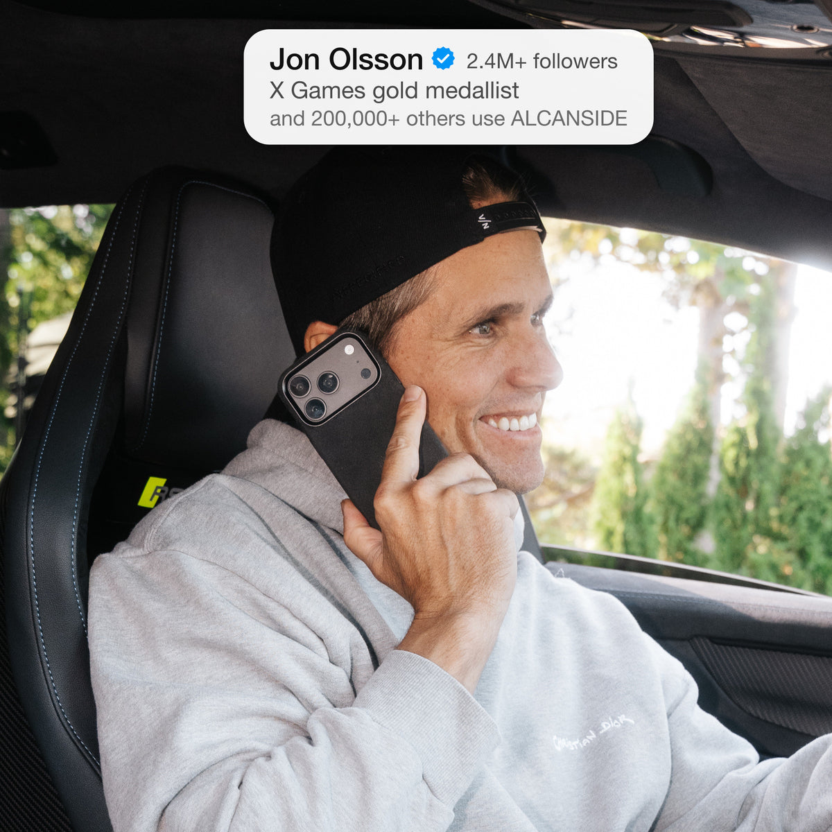Jon Olsson on the phone in his Audi RS6 with the Deep Black ALCANSIDE Alcantara case