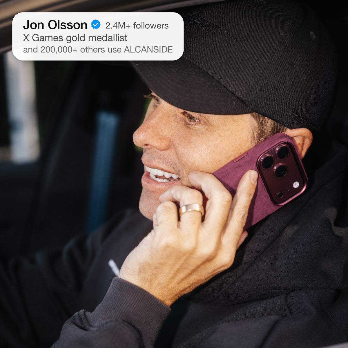 Jon Olsson with the Wine Red Alcantara case for iPhone 18 Pro held to the ear